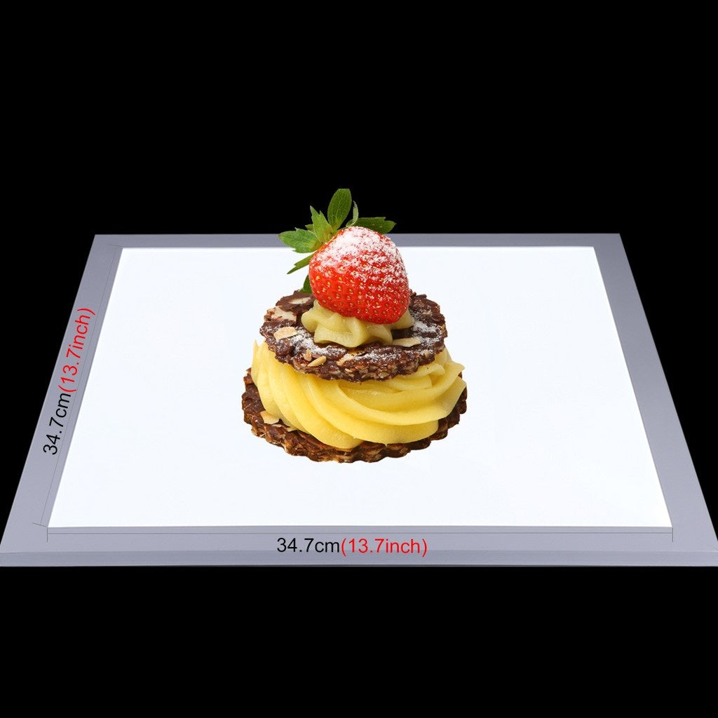 LED light panel for photography featuring a dessert with a strawberry and mint garnish
