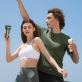 Portable mini handheld fan in green and white used by active young adults outdoors