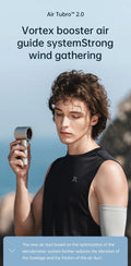 Portable mini handheld fan in silver held by a woman wearing a black sleeveless top outdoors