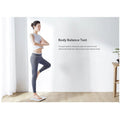 VMIDirect Smart Body Scale displayed with a woman performing a balance test in a bright room