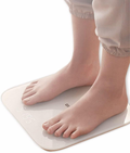 Smart Body Scale with a sleek design showing weight measurement under bare feet