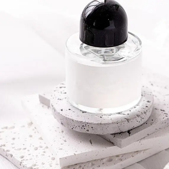 Natural Stone Props displayed with a clear glass bottle on textured surfaces for photography
