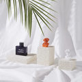 Display of Natural Stone Props with decorative items on textured white fabric backdrop