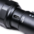 Close-up of a Rechargeable Tactical Flashlight featuring a USB charging port and durable design