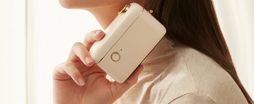 VMIDirect Portable Bluetooth Thermal Label Printer Maker held against a person's shoulder for easy portability