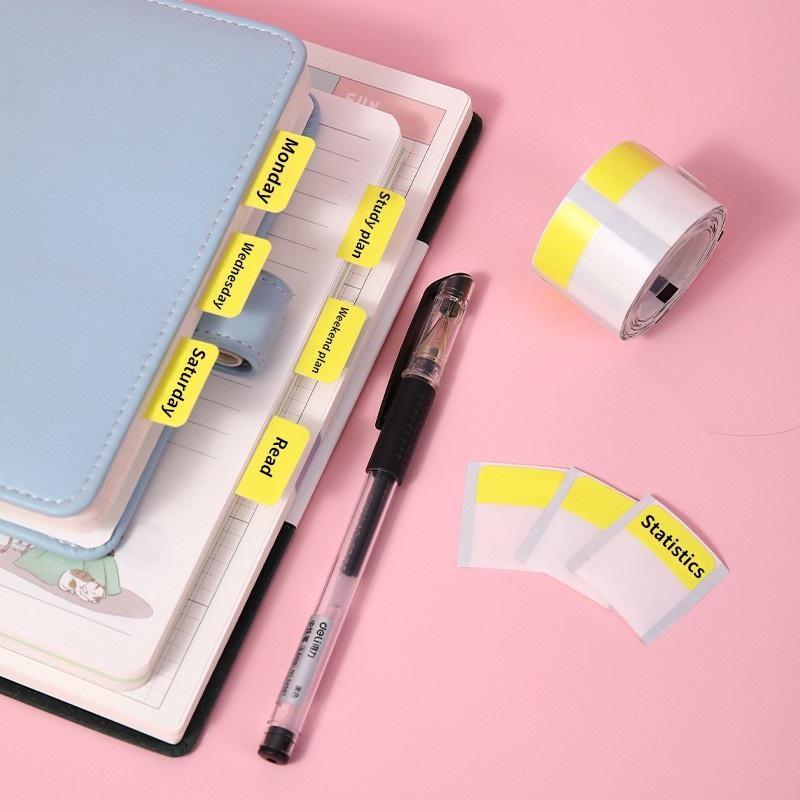 Colorful Thermal Label Stickers Patterned organized on a planner with a pen for easy indexing