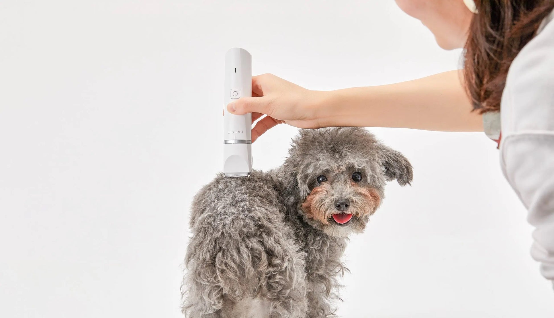 VMIDirect Pet Trimmer Clippers being used on a fluffy dog for easy grooming