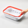 Portable Cat Litter Waste Receptacles Bag being placed in a plastic container for easy litter disposal