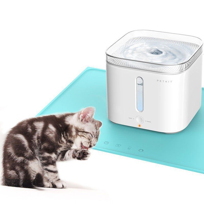 Silicone Pet Mat under a cat water fountain with a playful cat nearby for pet feeding and watering