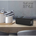 VMIDirect Portable Bluetooth Speaker on a wooden table with stylish decor elements