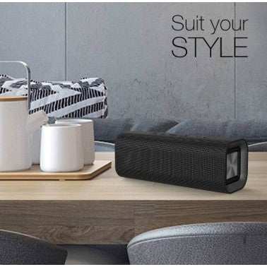 VMIDirect Portable Bluetooth Speaker on a wooden table with stylish decor elements