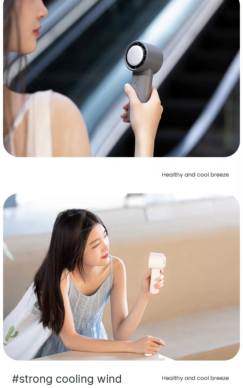 VMIDirect portable fan in hand, providing a cool breeze on a warm day outdoors