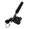 Professional handheld interview microphone with attached cable on a DSLR camera
