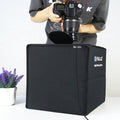 Folding Portable Ring Light with a photographer using a portable photo studio box