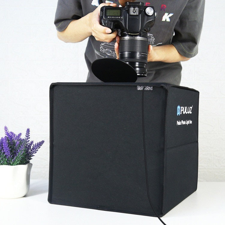 Folding Portable Ring Light with a photographer using a portable photo studio box