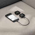 Rode Wireless ME Microphone System with smartphone connection on a gray sofa