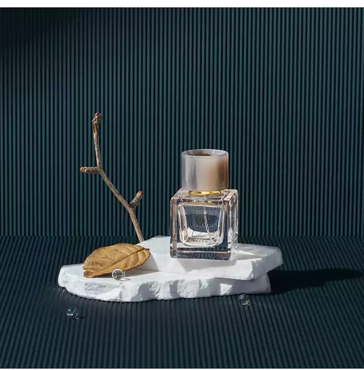 Striped Photography Background Paper with a decorative display featuring a perfume bottle and natural elements