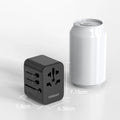 Portable universal charger for travel next to a soda can showing compact size and multiple plug outlets