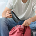 VMIDirect Portable Bluetooth Speaker held by a person sitting comfortably with casual attire