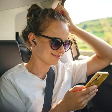 Woman in sunglasses enjoying music with VMIDirect Wireless Earphones Bluetooth in a car