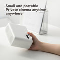 Hand holding white Wanbo Mini Pro smart projector small and portable for private cinema anytime