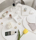 Wave Plaster Cutting Board Decoration on a white table with decorative items and accessories
