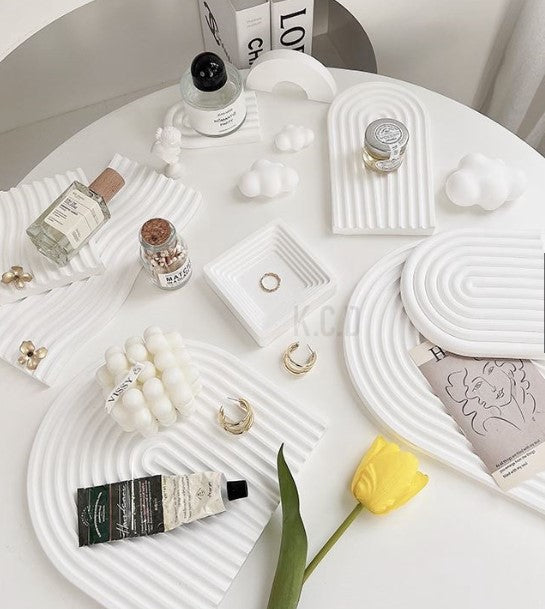 Wave Plaster Cutting Board Decoration on a white table with decorative items and accessories
