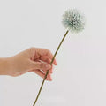Hand holding a single Artificial Flowers Silk stem in pastel colors for home decor