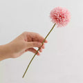 Hand holding a pink dahlia stem featuring Artificial Flowers Silk for decor and styling