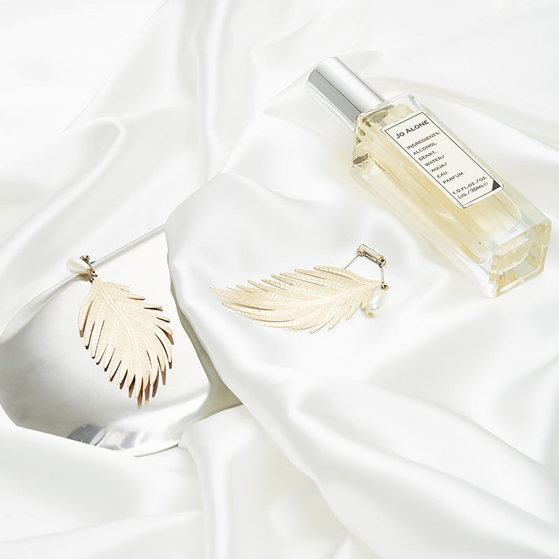 Elegant Cloth Photography Decoration Props featuring a perfume bottle and leaf-shaped jewelry on satin fabric