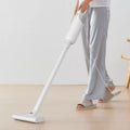VMIDirect Corded Vacuum Cleaner being used on hardwood floor by a person in casual attire