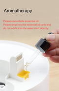 Close-up of hands adding essential oil to VMIDirect UV Lamp Sterilization Humidifier for aromatherapy