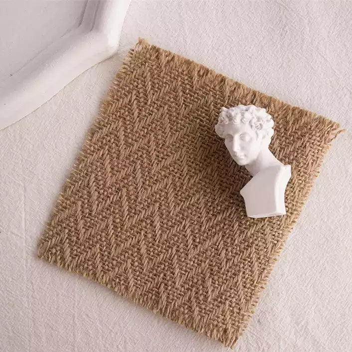 Linen Mat Photo Props with textured design and a white bust statue on top.