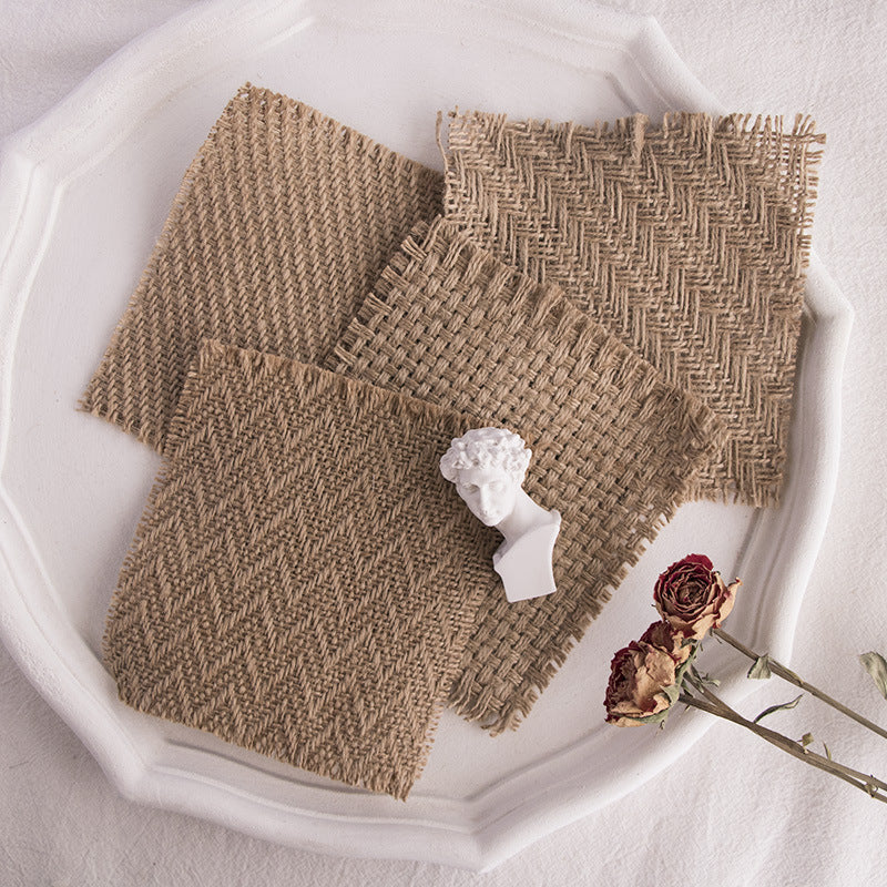 Four textured Linen Mat Photo Props arranged on a white plate for photography backgrounds