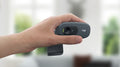 Hand holding a Logitech Webcam HD for clear video calls and streaming quality