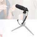 Multipurpose Video Microphone mounted on a tripod for smartphones with a user applying nail polish