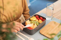 VMIDirect Portable Bento Lunch Box filled with fresh fruits and a fork on a table