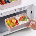 Portable Plastic Bento Lunch Box in pink with sections for rice and vegetables, perfect for meal prep