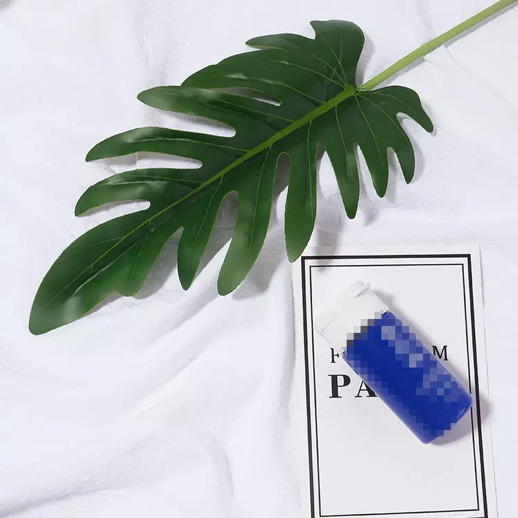 Simulation Artificial Green Plant Leaf on a Table with a Coffee Cup and Book