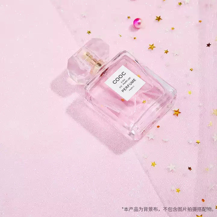 VMIDirect sparkling sky background with a pink perfume bottle and decorative confetti stars
