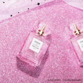 VMIDirect Sparkling Sky Background with two pink perfume bottles on a glittery surface