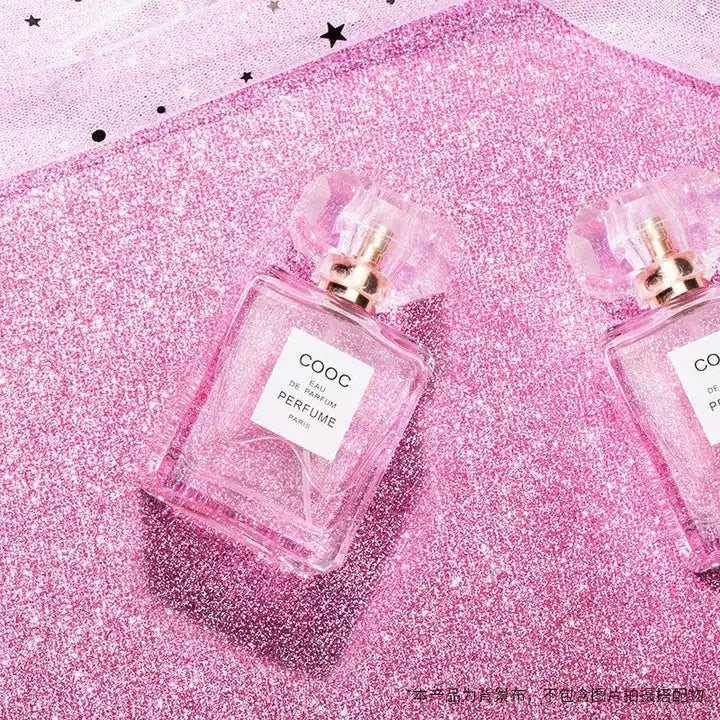 VMIDirect Sparkling Sky Background with two pink perfume bottles on a glittery surface