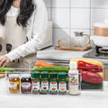 VMIDirect Stackable Pantry Organizer with clear containers for spices and vegetables in a kitchen setting