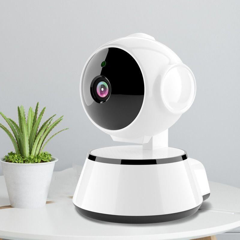 VMIDirect WiFi CCTV Camera on a table with a green plant, designed for home security monitoring