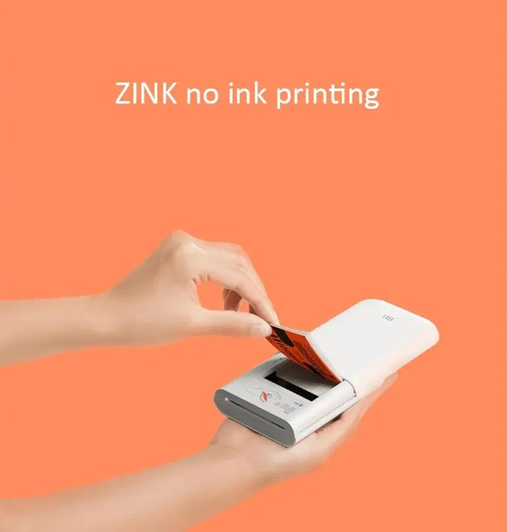Person holding Pocket Photo Printer Paper for ZINK no ink printing in a compact printer